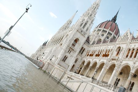 Big flood of the river danube covers the street in front of the Parliament buildingの写真素材