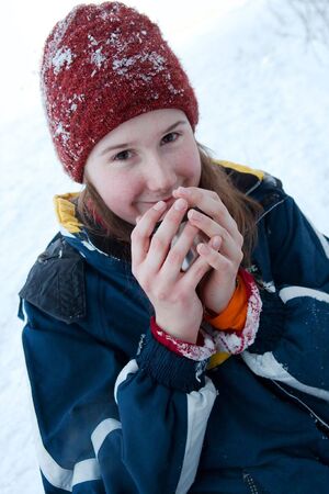 Girl drinking hot tea in the cold winterの写真素材