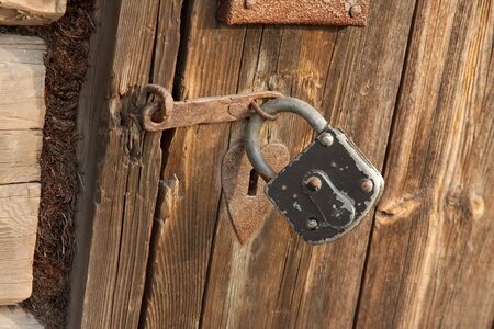 Padlock on an old wooden doorの写真素材