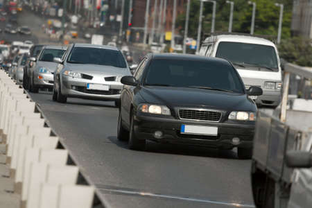 Cars passing by on a busy urban roadの写真素材