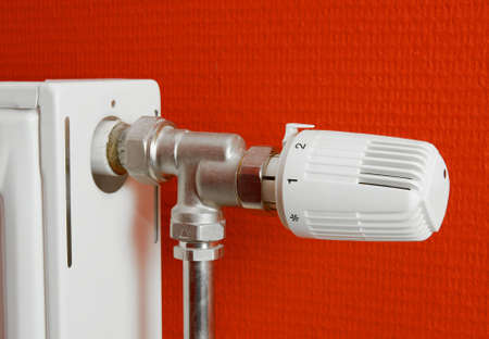 Detail of a heating radiator against red wallの写真素材