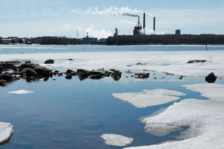 Smoking industrial plant and melting iceの写真素材