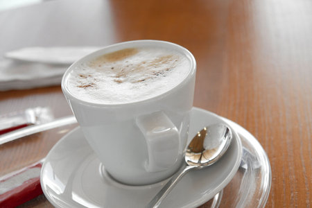 A cup of coffee in soft morning light, shallow DoF