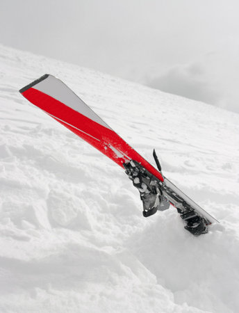 Ski crashed into deep fresh snowの写真素材