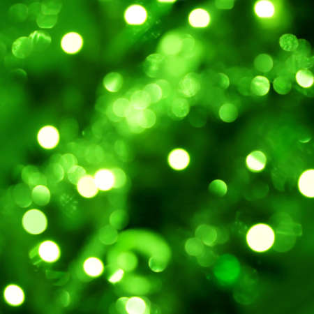 Background with out of focus light dots in greenの写真素材