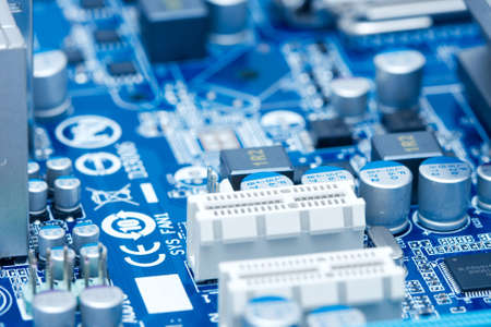 Deatil of a computer motherboard with lots of electronic componentsの写真素材
