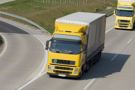 Yellow trucks roaring on the highway