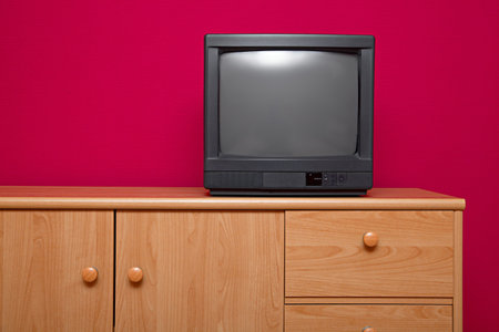 TV set in a room with red wallの写真素材