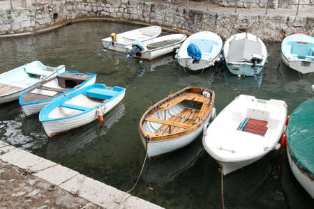 Small boats in the dock of a mediterranean villageの写真素材