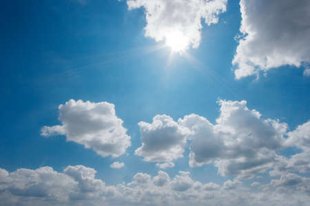 Bright sky with rays of sun filtering through the cloudsの写真素材