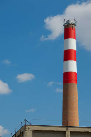 Industrial chimney against blue skyの写真素材