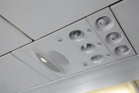 Interior of a plane, ovehead panel with no smoking sign