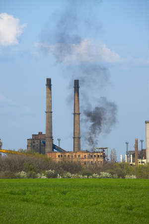 Old industrial plnat with smoke risingの写真素材