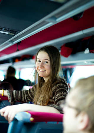 Smiling girl traveling by busの写真素材