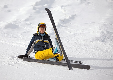 Skier resting sitting in the snowの写真素材