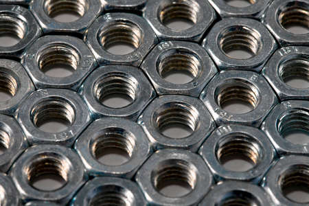 Metal nuts in an organized array patternの写真素材