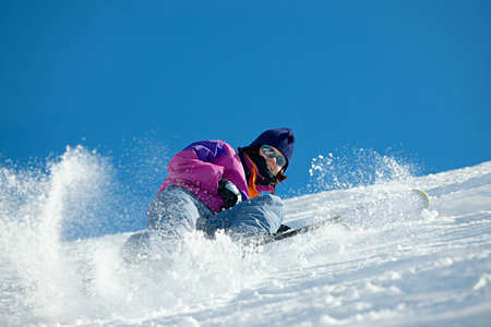 Female skier coming down the slopeの写真素材