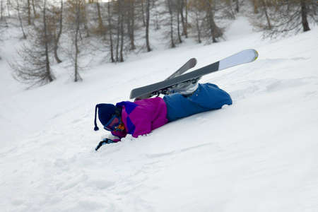 Skier fallen over in the snowの写真素材