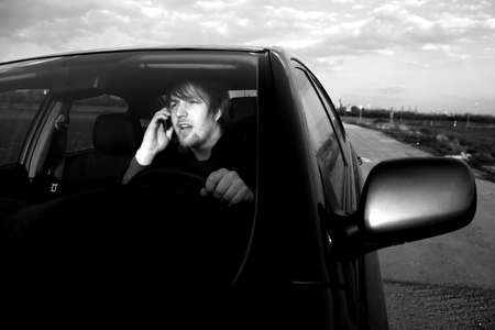Man calling on the phone while drivingの写真素材
