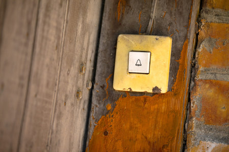 Doorbell button at an old gate