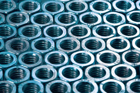 Metal nuts forming a backgroundの写真素材