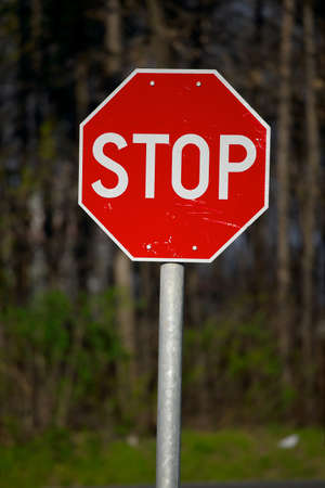 Stop sign closeup with woods in the backgroundの写真素材