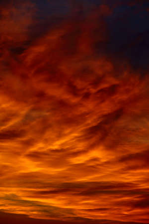 Dramatic sunset sky with clouds glowing redの写真素材