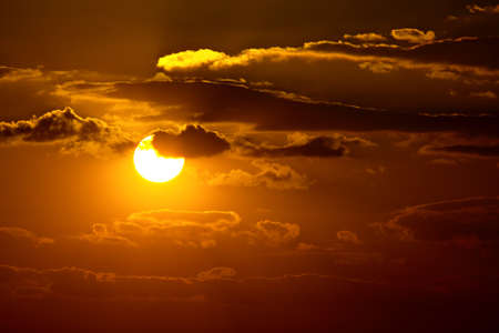 Sunset sky with clouds and sunの写真素材