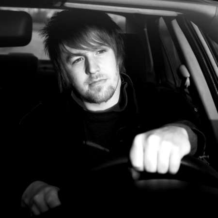Man driving a car in black and whiteの写真素材