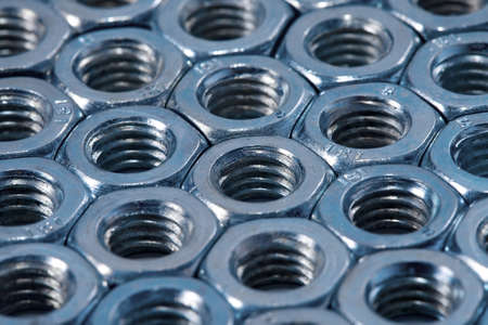 Array of shiny metal nutsの写真素材