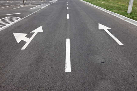 Directional arrows on the asphalt surfaceの写真素材