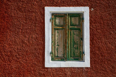 Shuttered window of an old buildingの写真素材