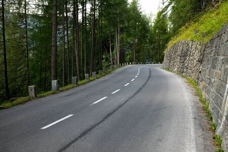 Mountain road with woodsの写真素材