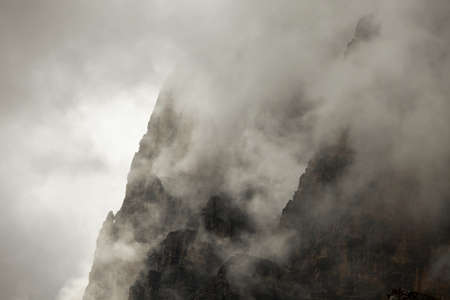 Foggy mountain cliffs of a steep ridgeの写真素材