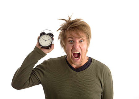Yelling man with alarm clock in handの写真素材