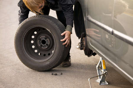 Changing wheel on a car on the roadsideの写真素材