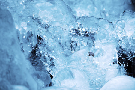 Ice background of a small stream in winterの写真素材