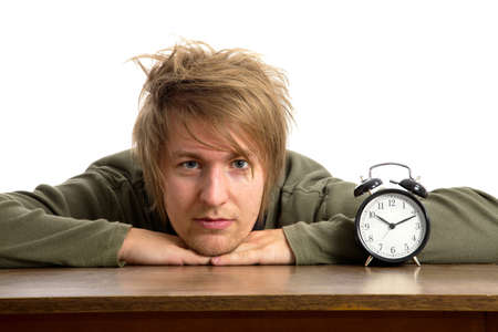 Male portrait with alarm clockの写真素材