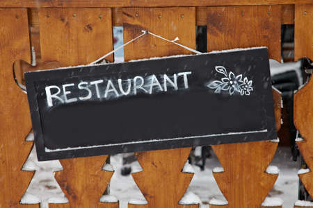 Sign at the entrance of a restaurantの写真素材