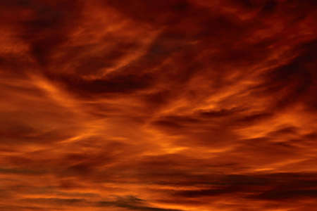 Red, cloudy sky at sunsetの写真素材