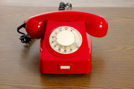 Red, vintage telephone on a tableの写真素材