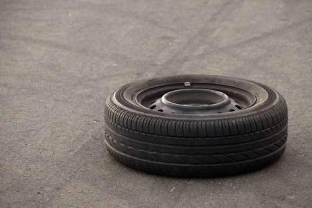 A wheel of a car left on the roadの写真素材
