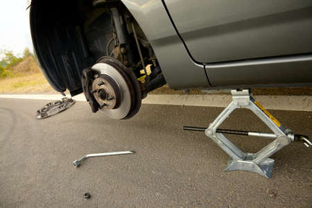 Changing a broken wheel on a carの写真素材