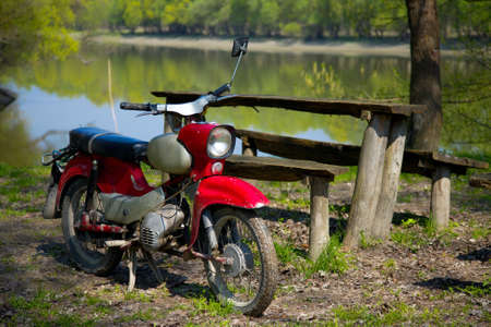 Old simple motorbike at the riversideの写真素材