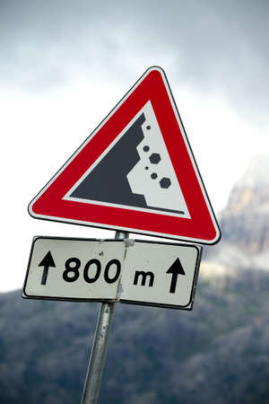 Warning sign of falling rocks on a mountain roadの写真素材
