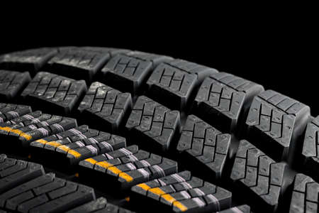 Winter tyre closeup on black backgroundの写真素材