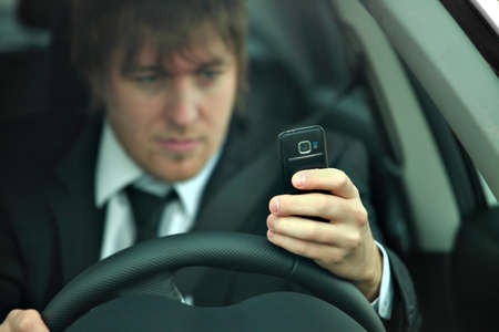 Man texting and drivingの写真素材