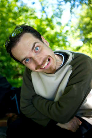 Man sitting and putting crazy expressionの写真素材