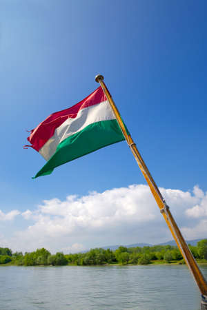 Hungarian national flag over a riverの写真素材