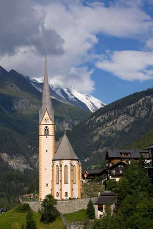 Church in heiligenblut, Austria, with the Grossglockner peak in the backgroundの写真素材